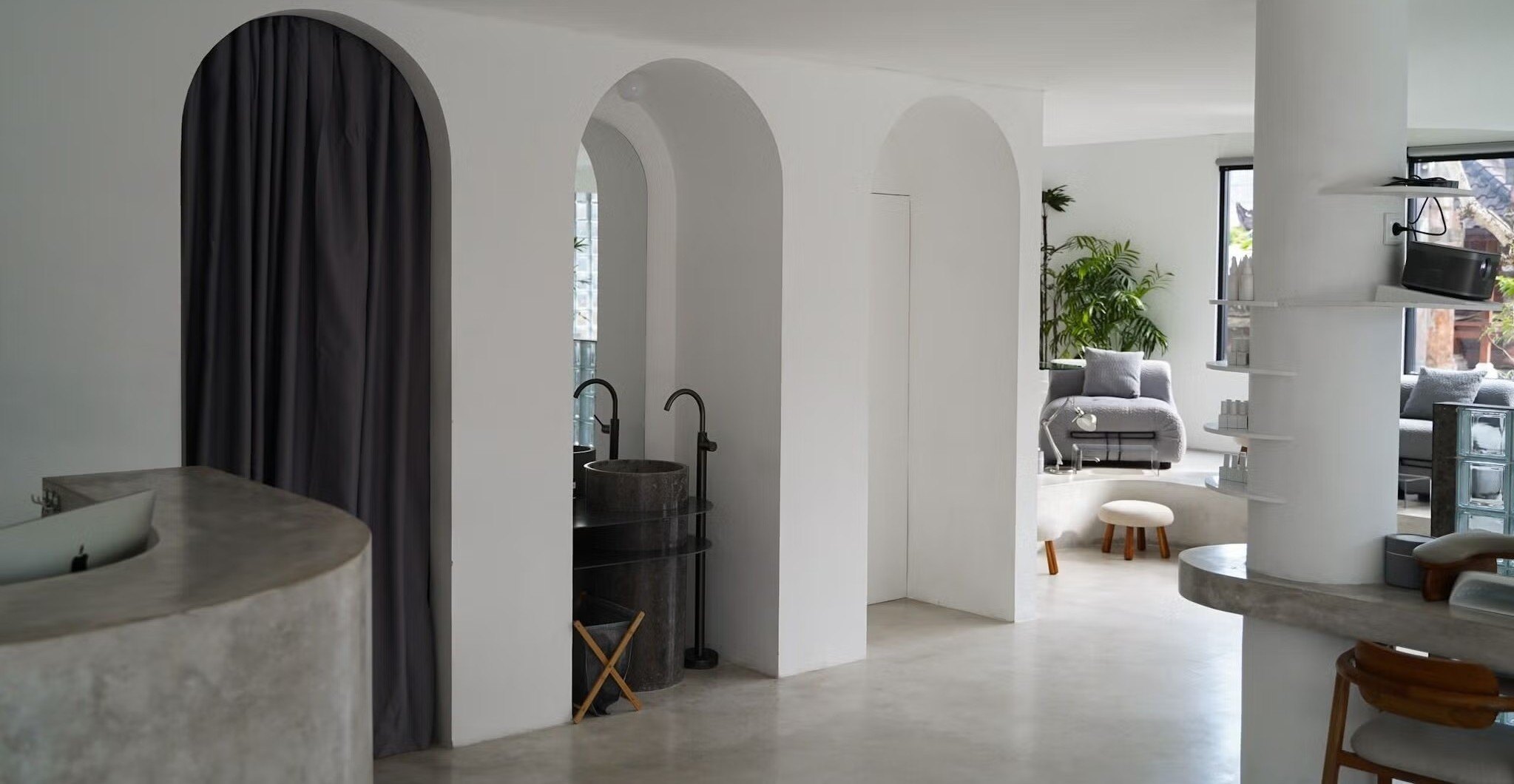 Airy white nail studio with arched alcoves